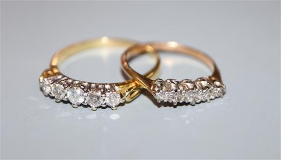 A modern 18ct gold and five stone diamond half hoop ring and one other yellow metal and five stone diamond ring.